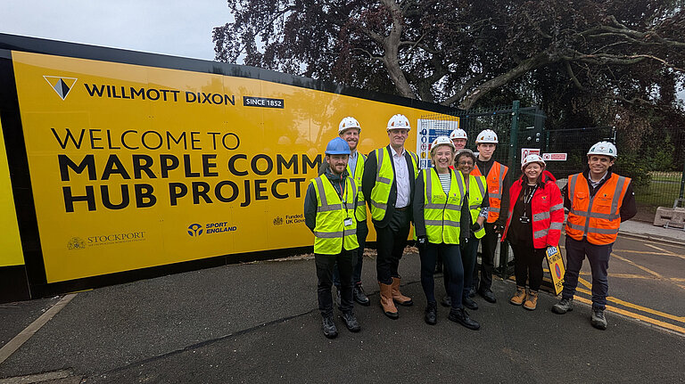 Lisa, Shan and site workers outside the new Marple Community Hub site