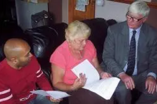 Plan of action: Buersil Post master Jay Patel, resident Carol Hoye and Rochdale MP Paul Rowen go through their plans to try and save their local Post Office
