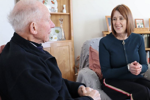 Jane Dodds listening to an older man